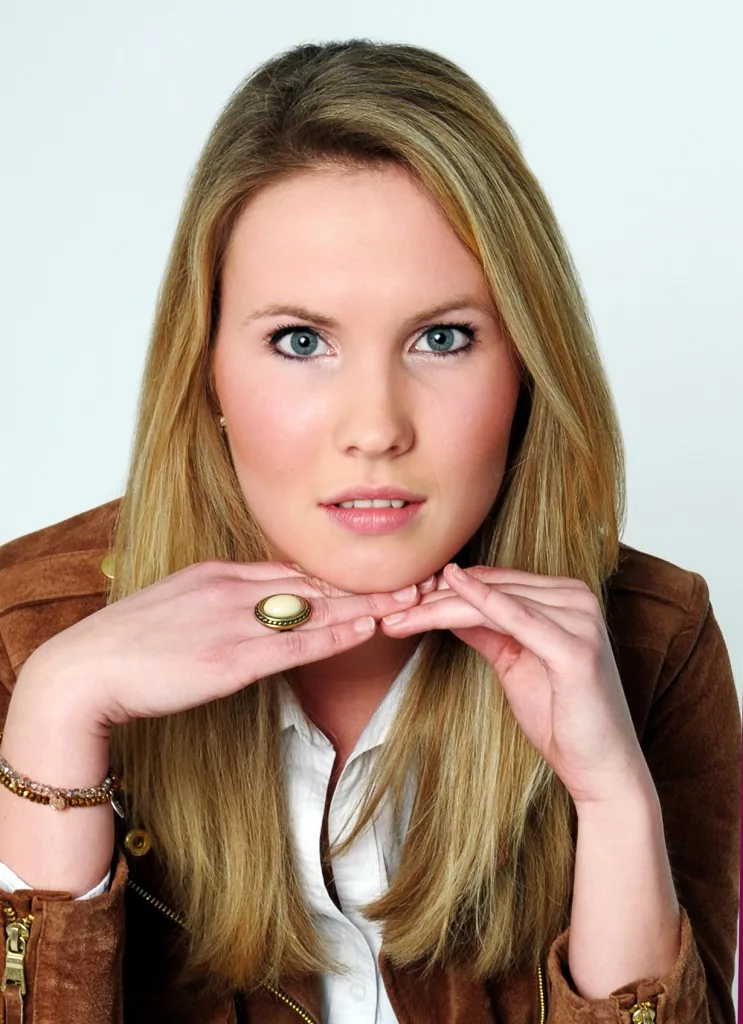 Beauty-Portrait einer jungen Frau, das Kinn auf die Hände gestützt